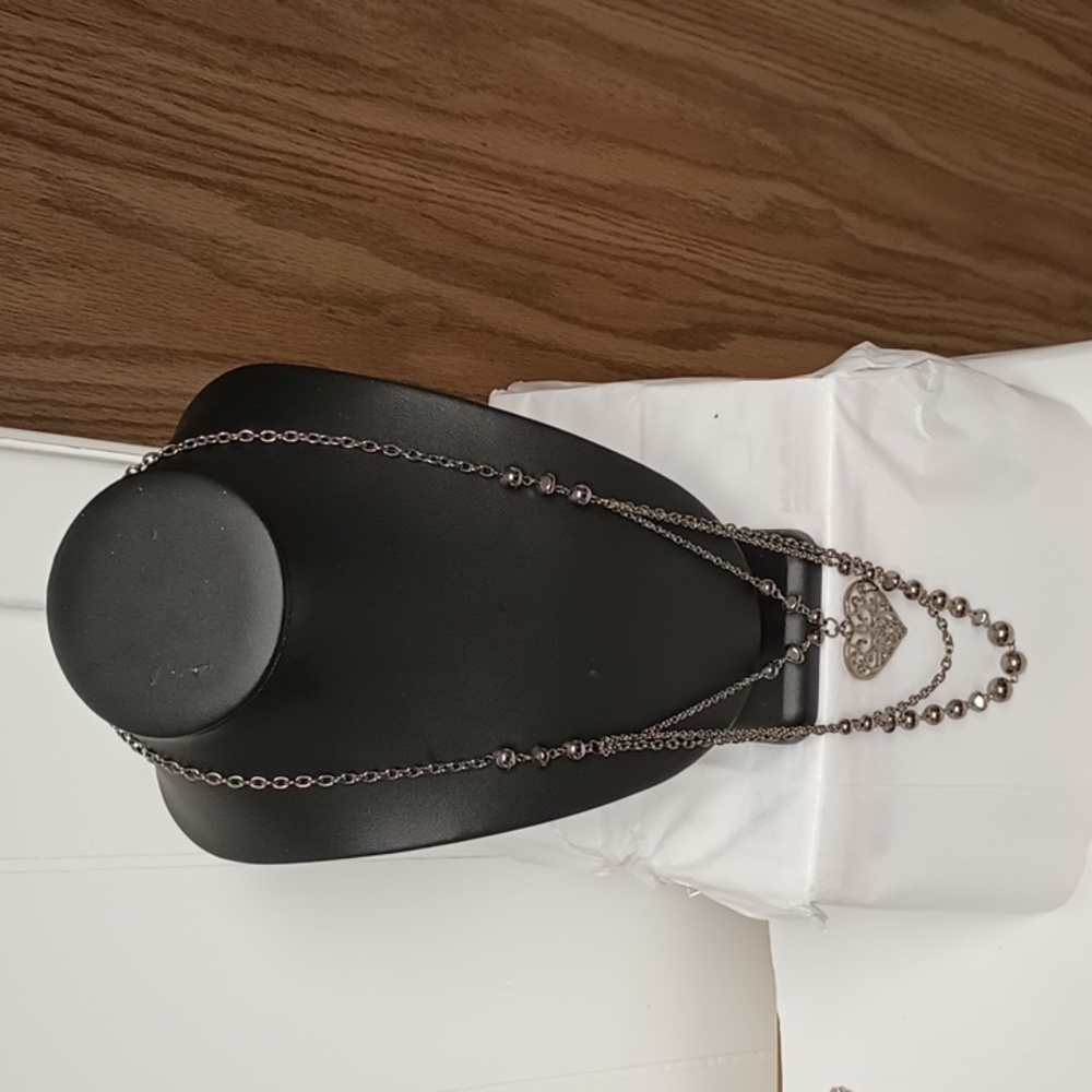 Long blackish silver tone chain with heart and beads.